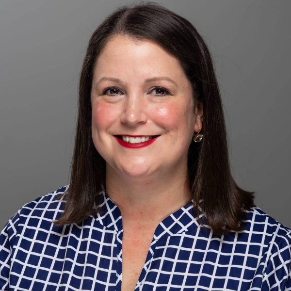 a person wearing a blue and white, grid-patterned shirt. Randolph Riverfront Center team